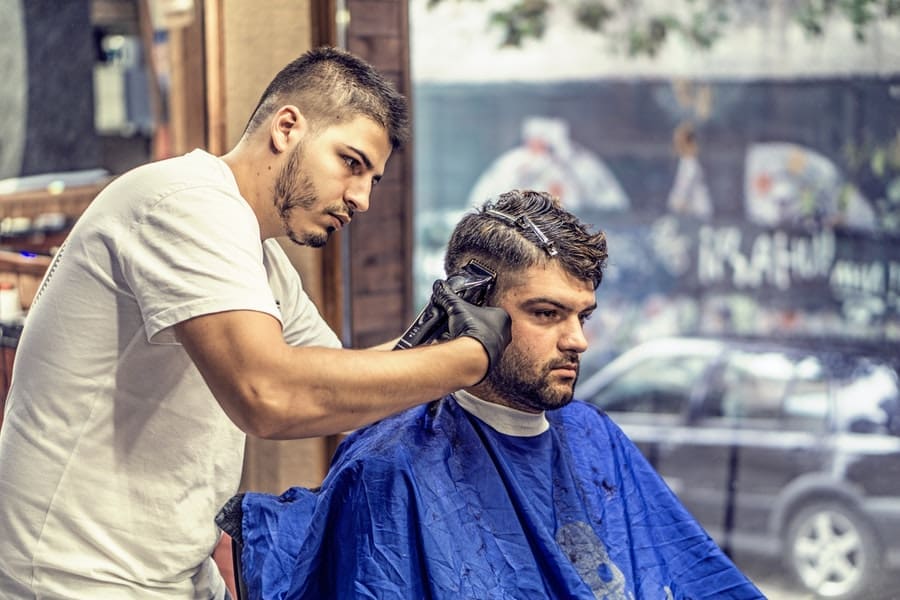 pexels-photo-163569 Male hairdresser cuts another man's hair