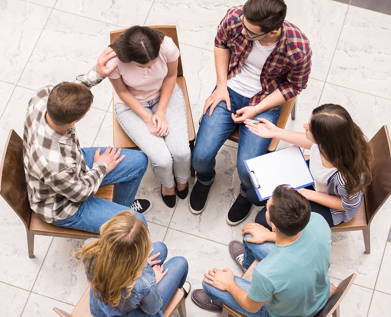 Group of people sitting close to each other.