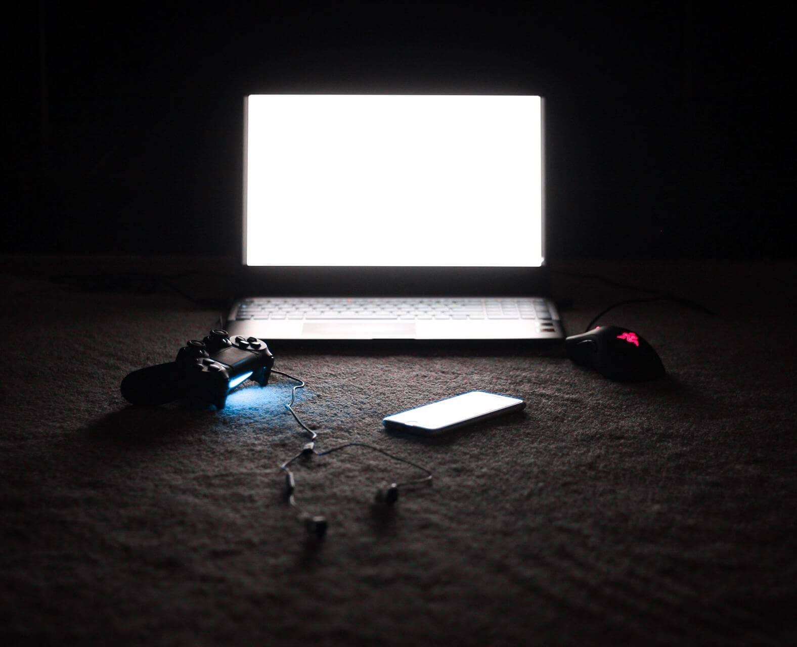 E-Sports: are they a real sport? Computer, cellphone and video game controller sit in darkened room