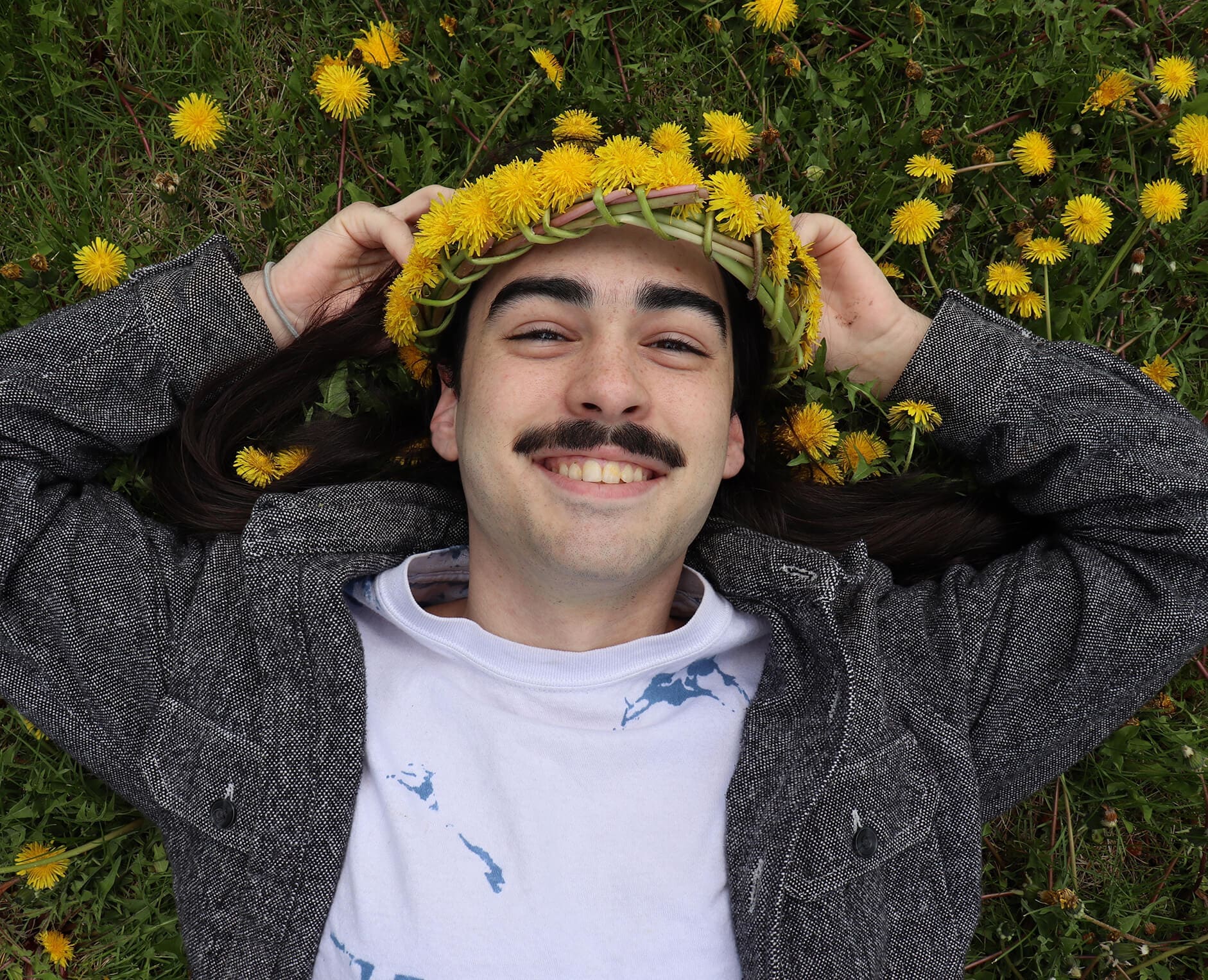 DIY Flower Crown man wearing flower crown laying in grass