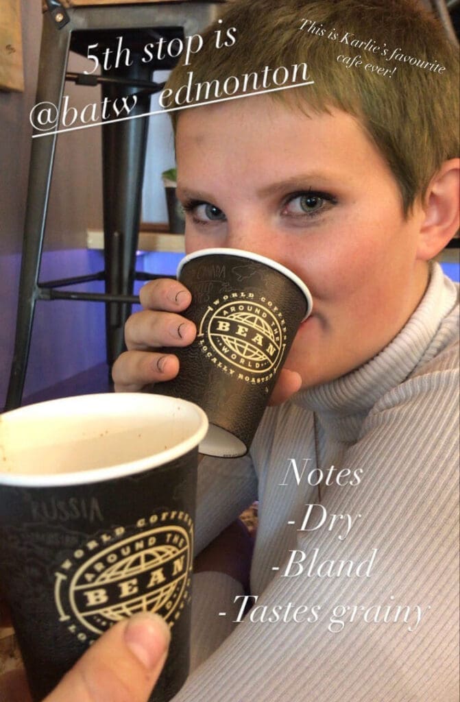 woman sips cup of coffee in a cafe