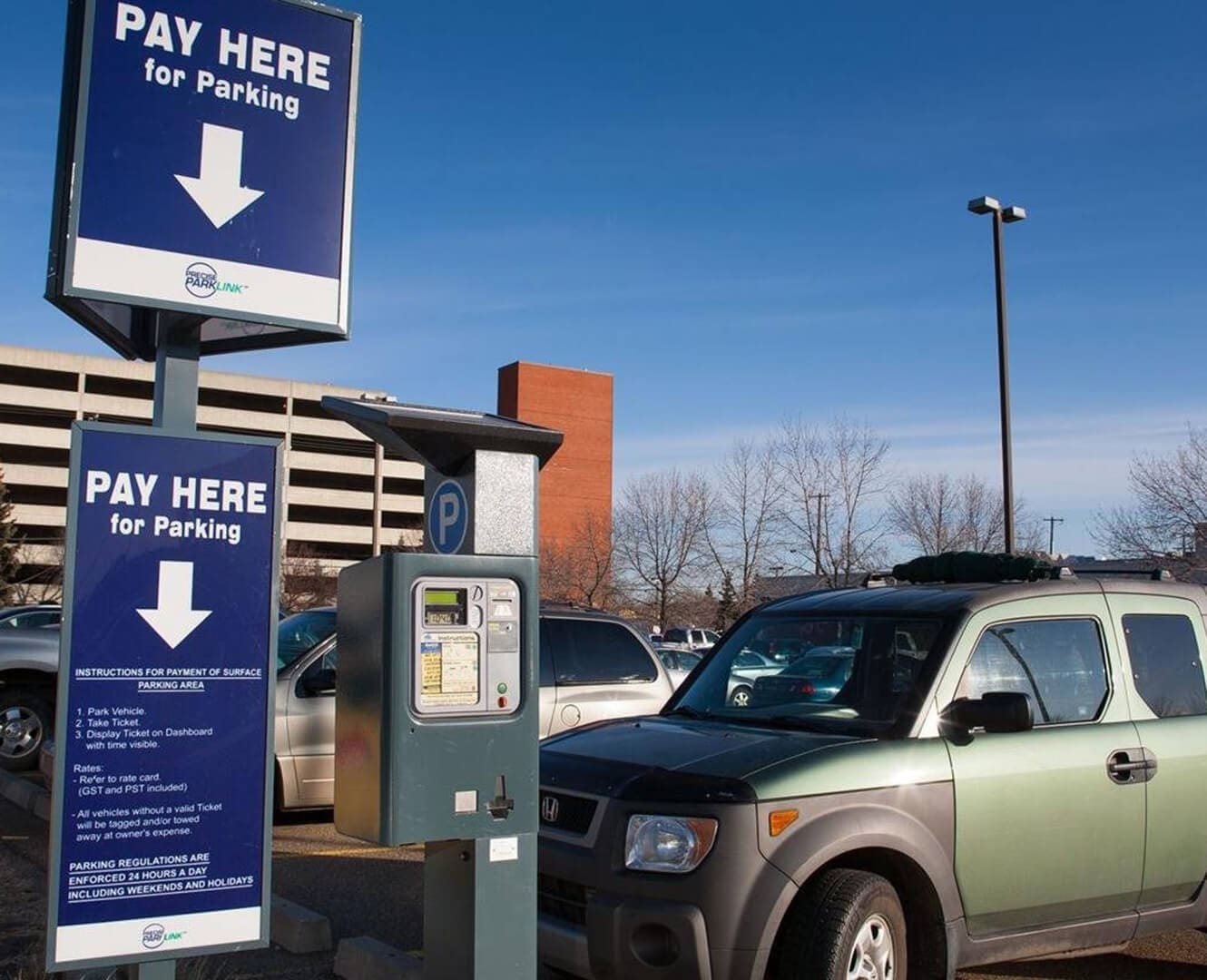 Car is parked next to toll payment machine