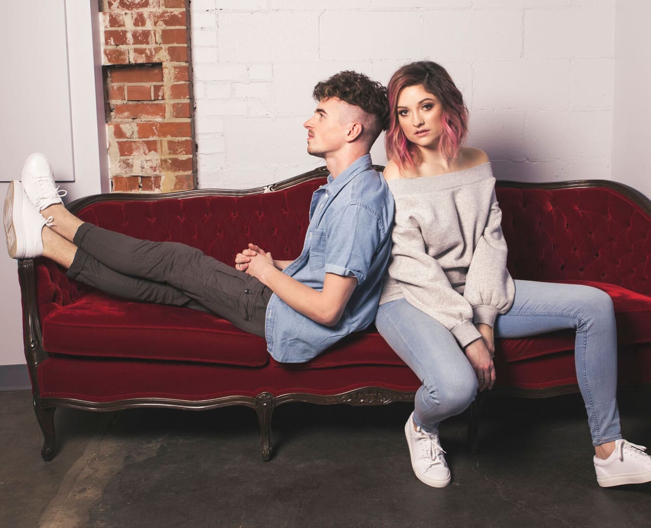Local Pop Duo Share Their Love Language Through Music and Activism Jenesia Band sits on couch