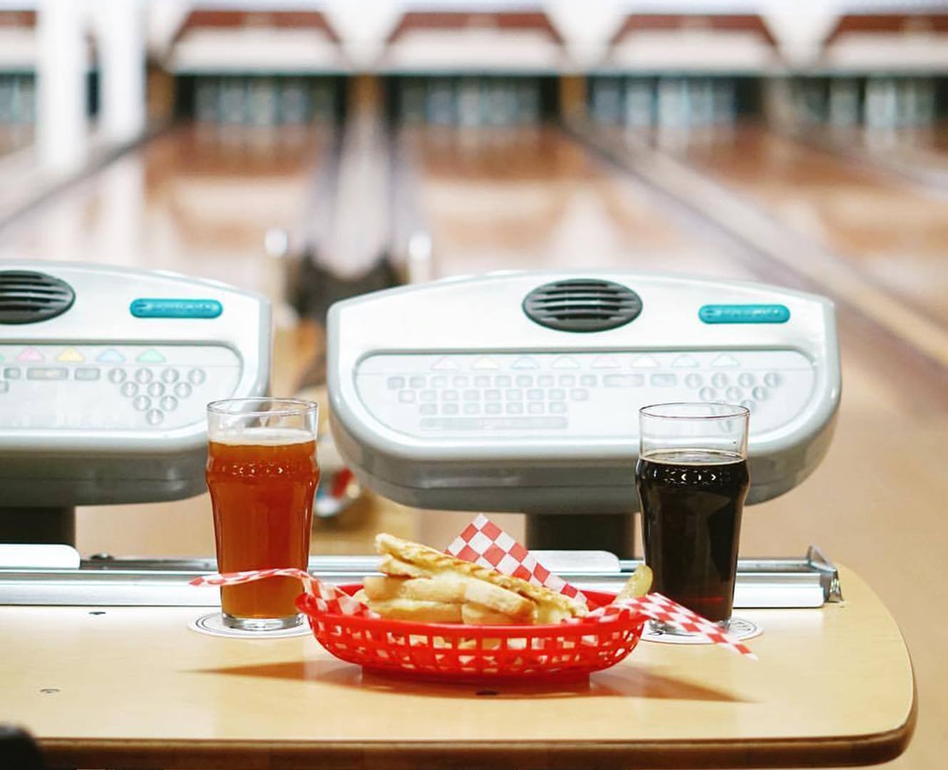Grabbing Grub Off-Campus: Neighbourhood Spots to Try A bowling lane with a table and fries with 2 glasses of pop