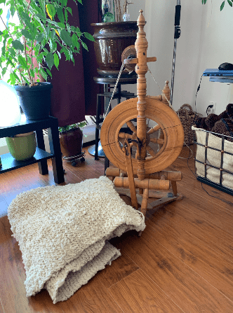 a spinning wheel and a yarn blanket 