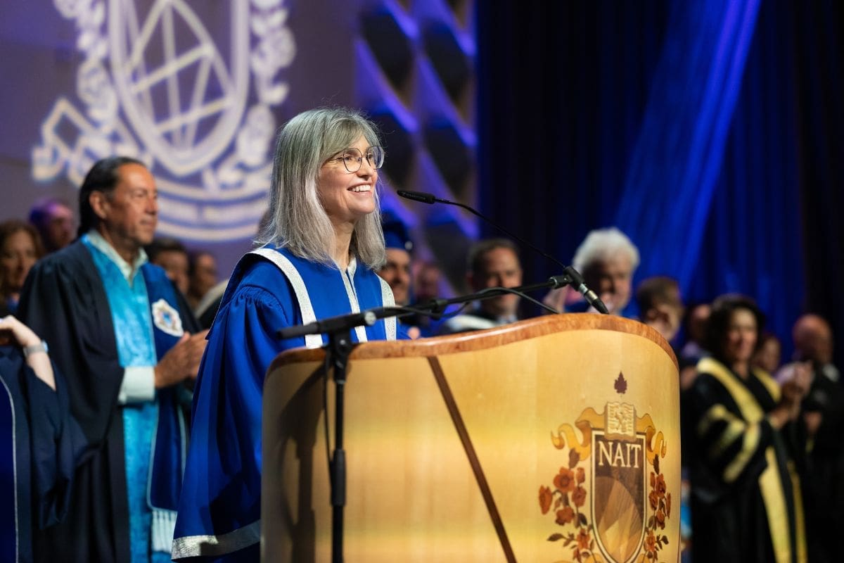 Laura Jo Convocation 2025 NAIT President Laura Jo Gunter smiling in front of a wooden podium at Convocation 2025.