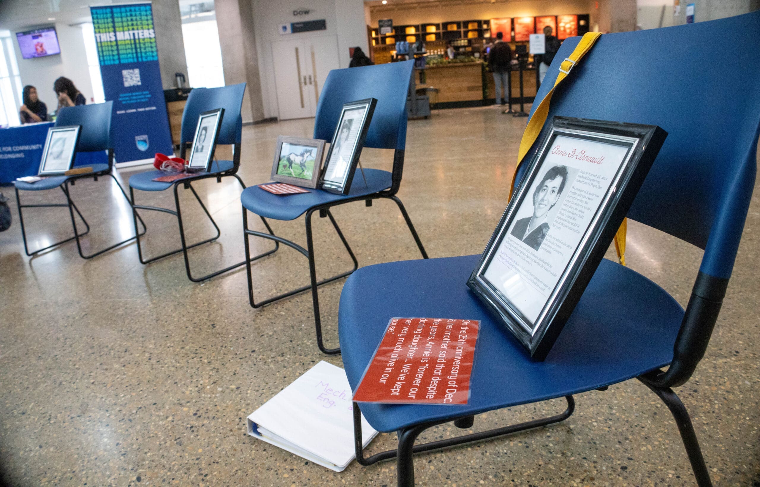 A mechanical engineering textbook sits on the floor near Annie St. Arneault's display.